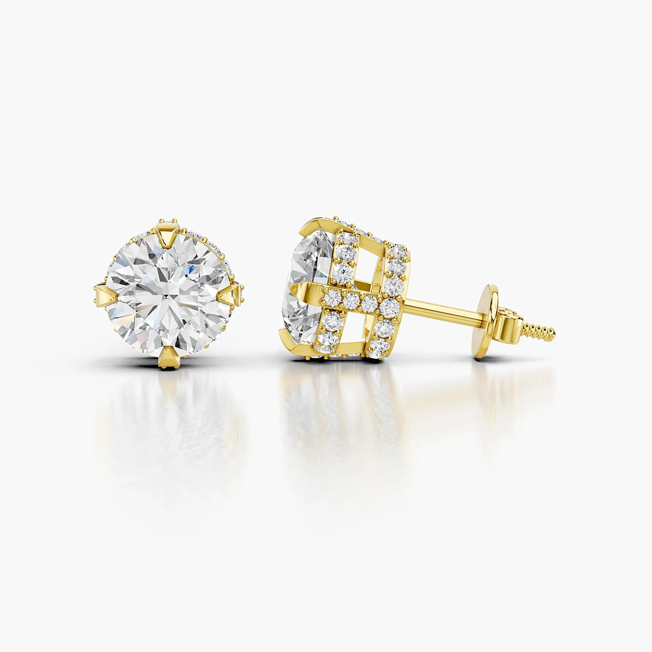 Pair of round diamond stud earrings with pavé cross-halo baskets and prominent solitaire centres.