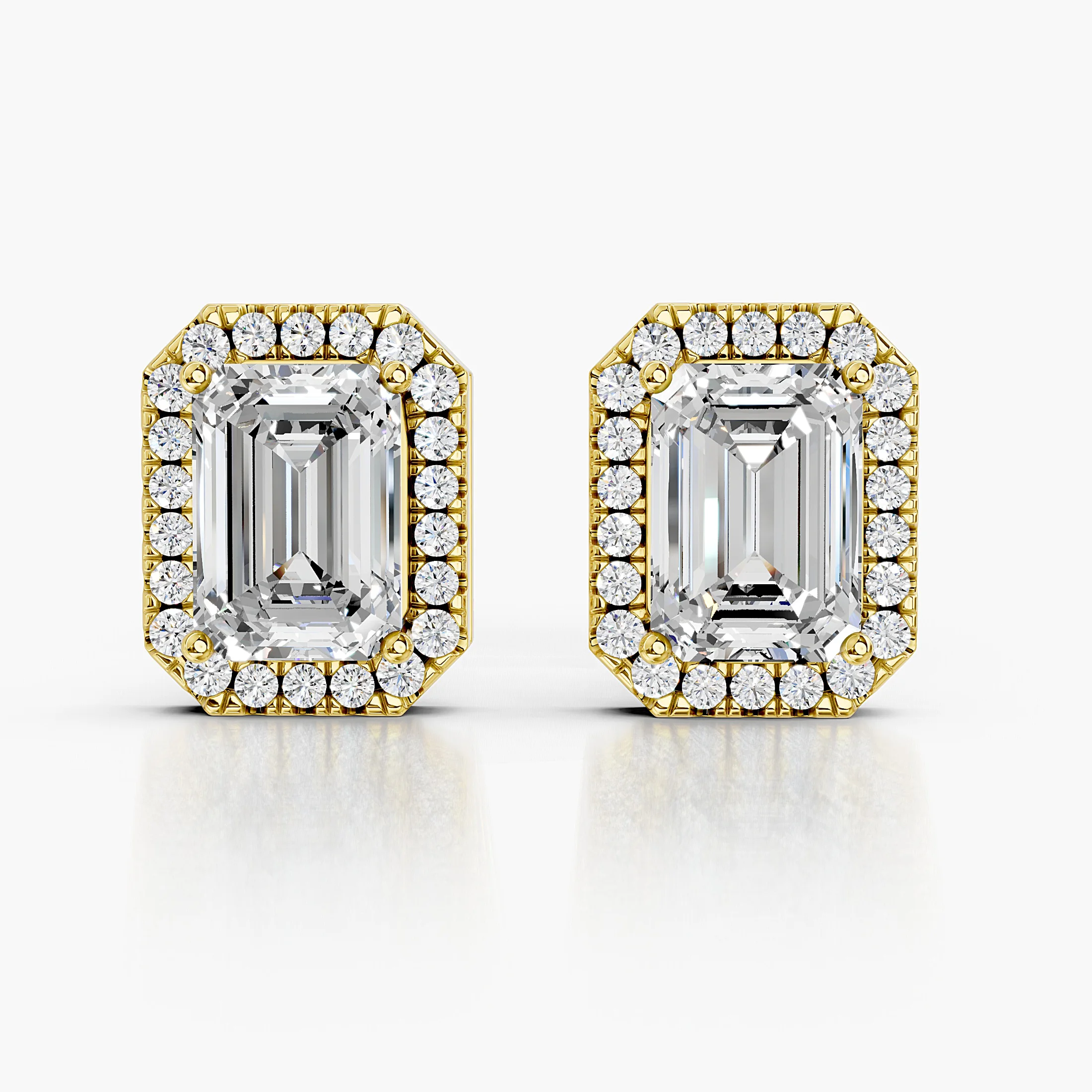 Emerald-cut diamond stud earrings with clipped-corner round diamond halos.