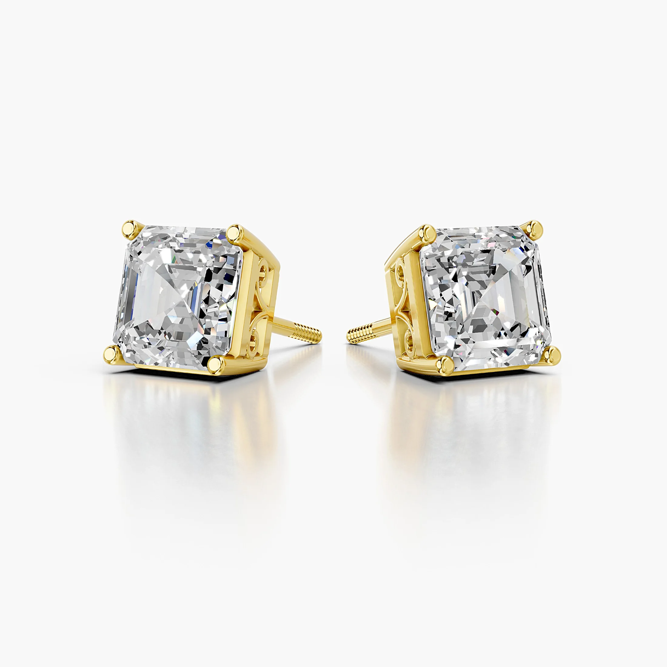 Pair of emerald-cut lab-grown diamond solitaire stud earrings in four-prong settings.