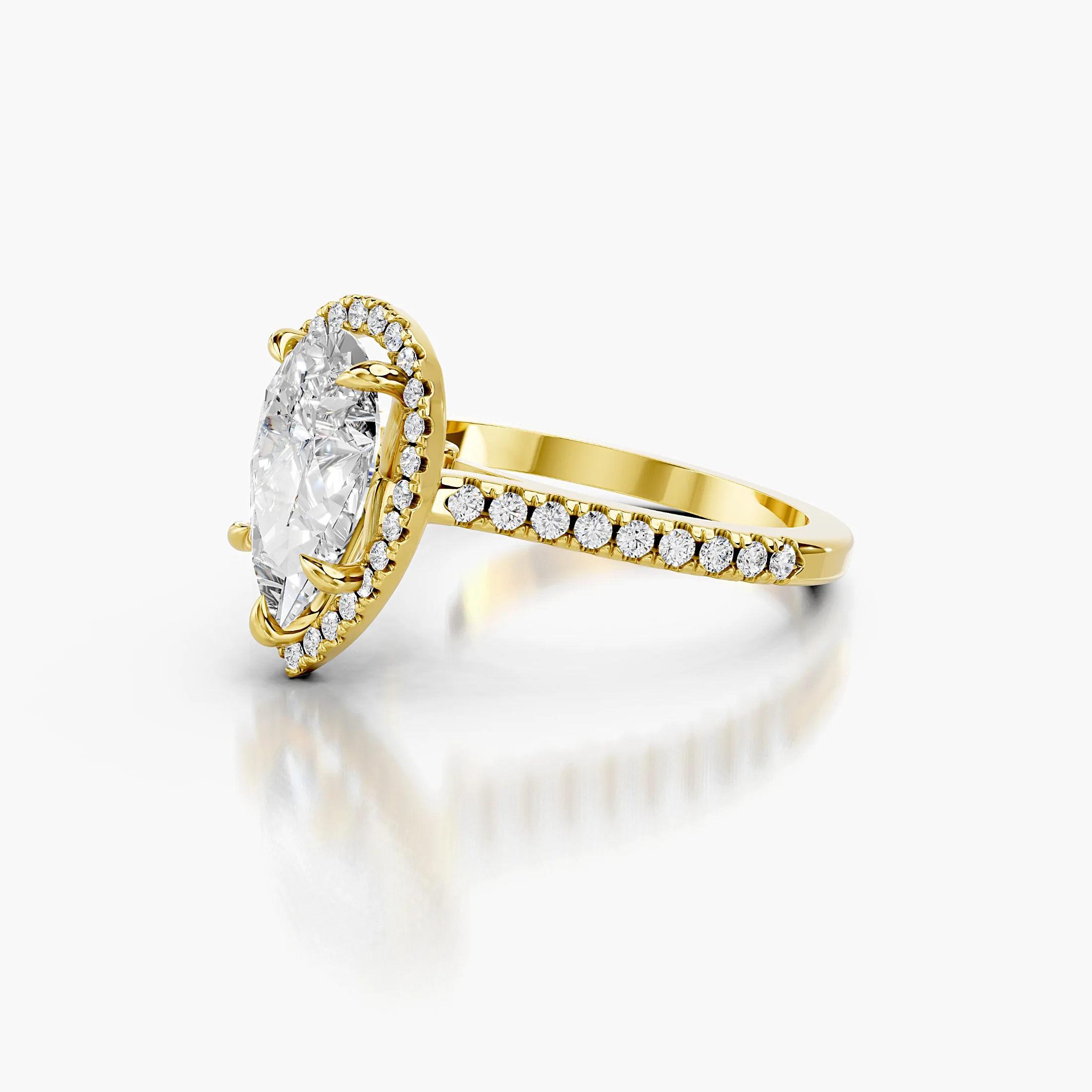 Pear-cut lab-grown diamond engagement ring with a matching halo and diamond-set band.