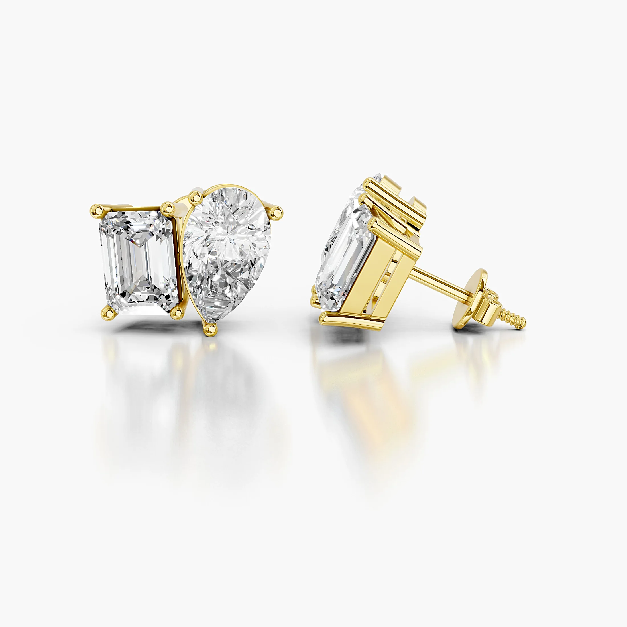 Pear-cut and emerald-cut diamond duo stud earrings in a mirrored design.