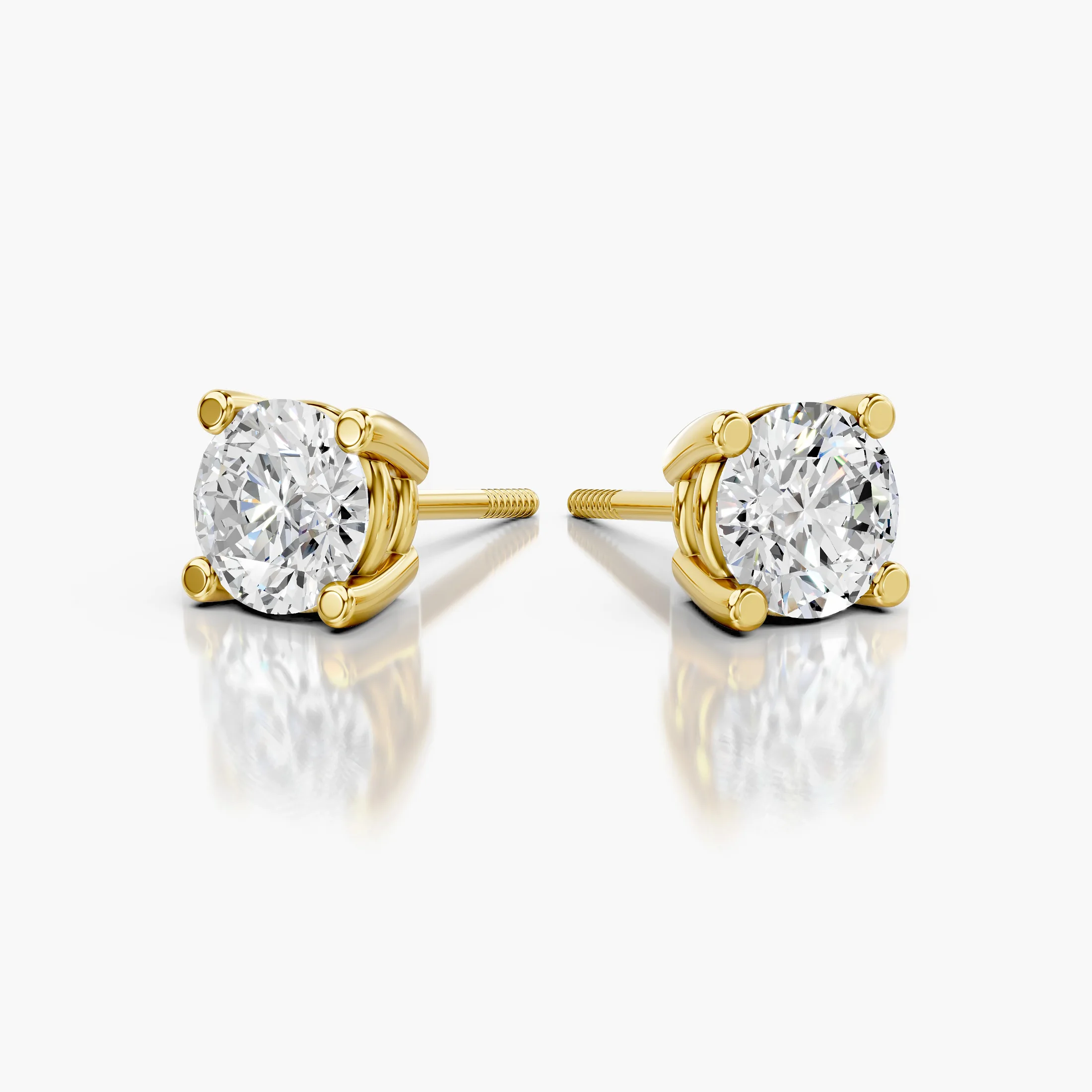 Round diamond solitaire stud earrings with four-prong basket settings and screw-back closures