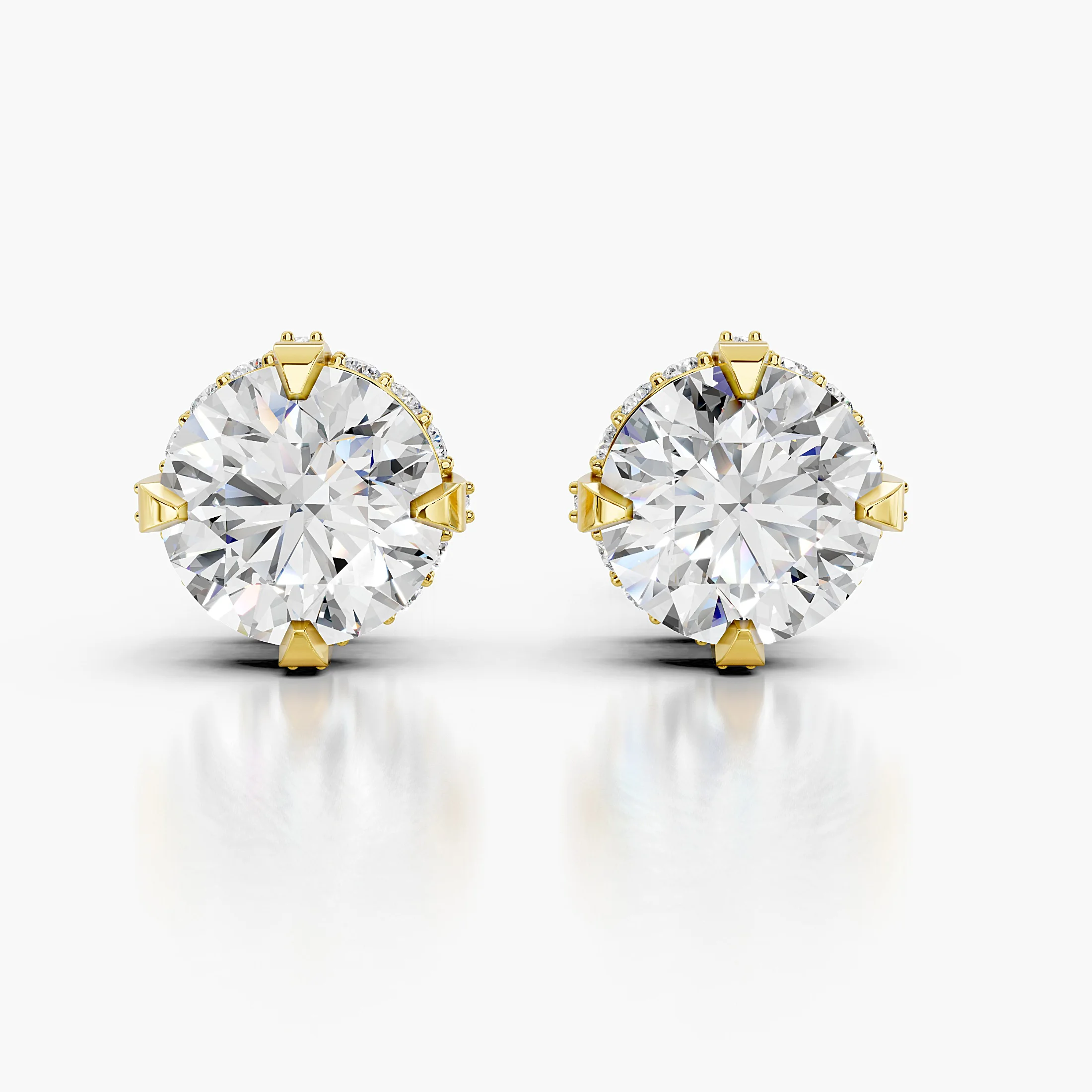 Pair of round diamond stud earrings with pavé cross-halo baskets and prominent solitaire centres.