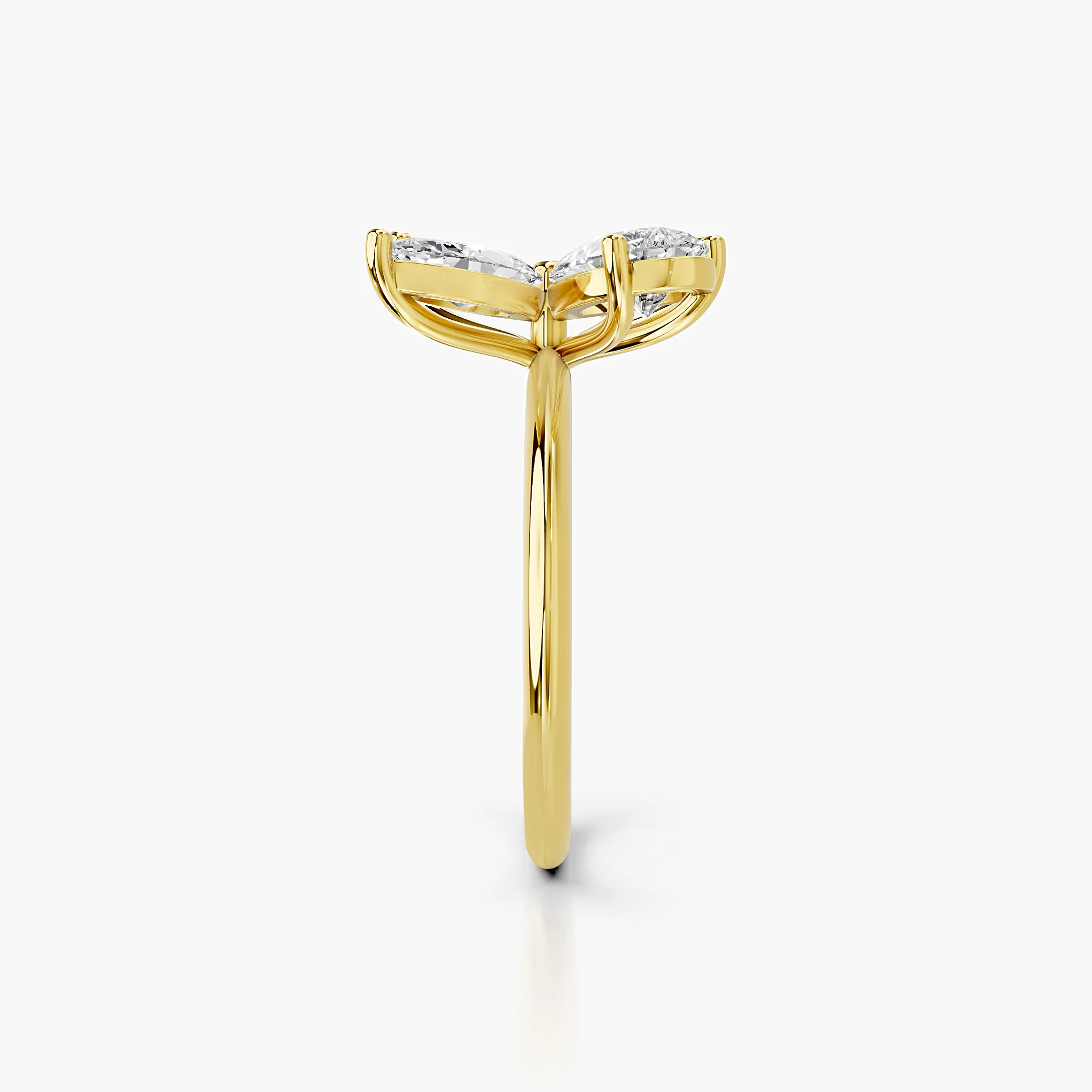 Four-petal diamond ring formed by two pear-cut and two marquise-cut stones on a polished band.