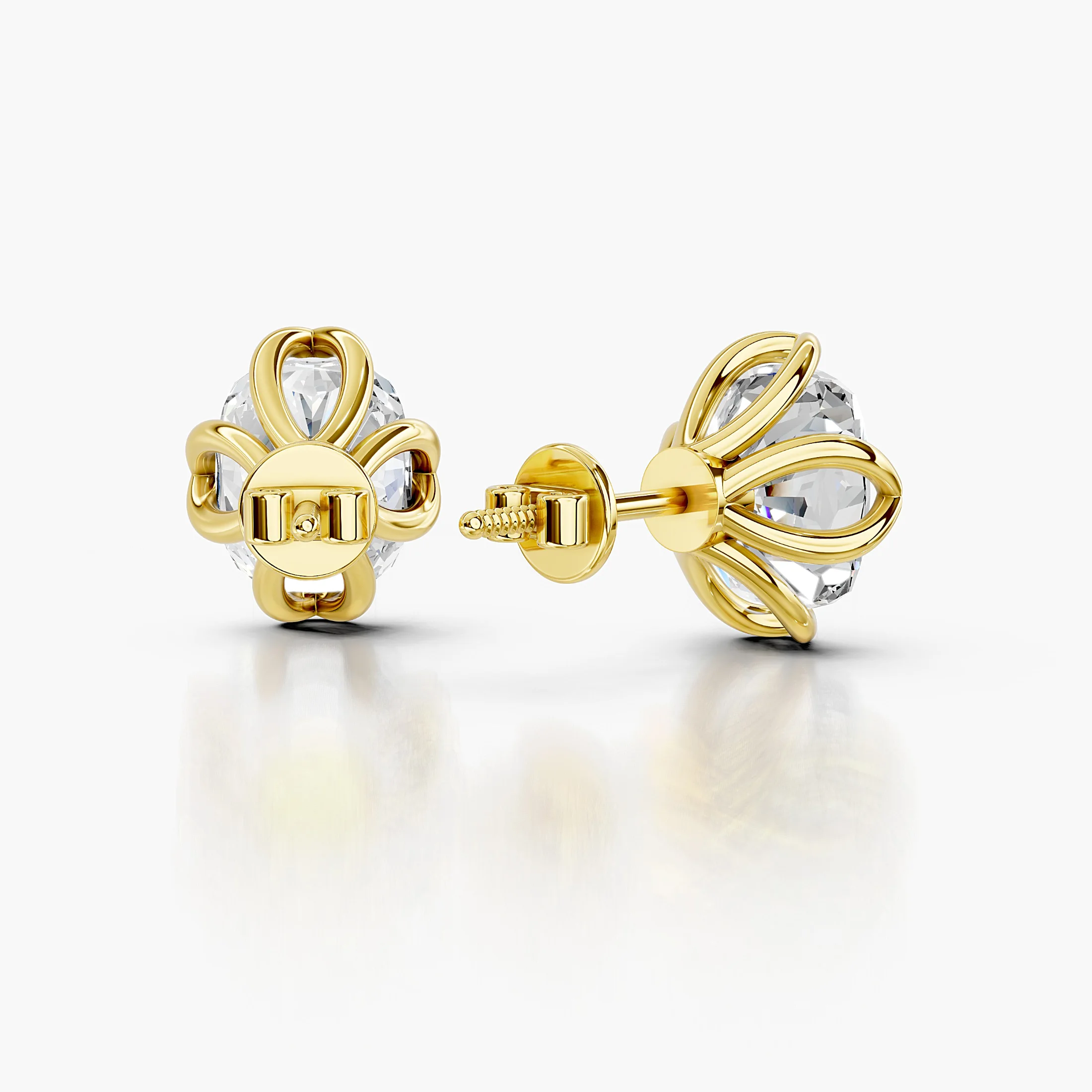 Cushion-cut diamond solitaire stud earrings with sculpted four-prong settings.