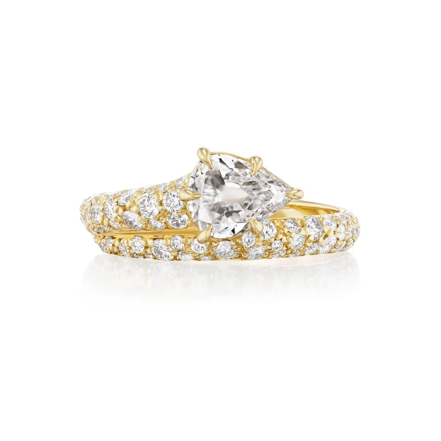 Pear-shaped diamond engagement ring with a multi-row pavé bypass band