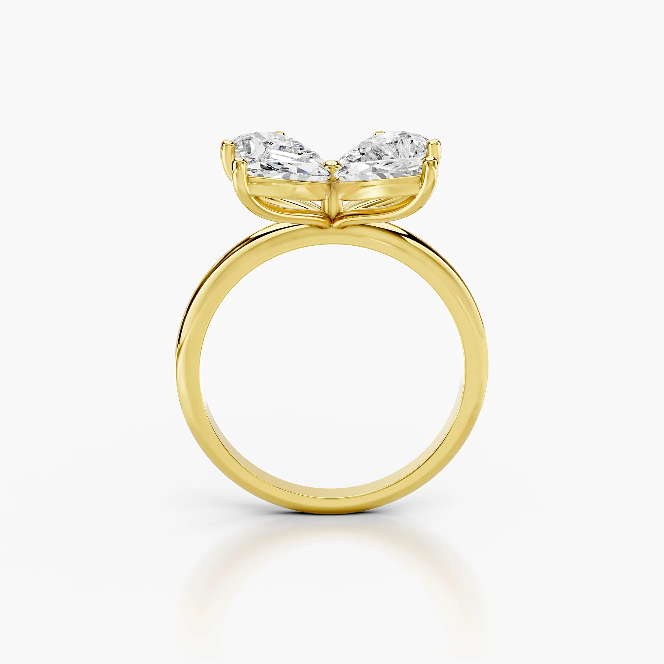 Four-petal diamond ring formed by two pear-cut and two marquise-cut stones on a polished band.