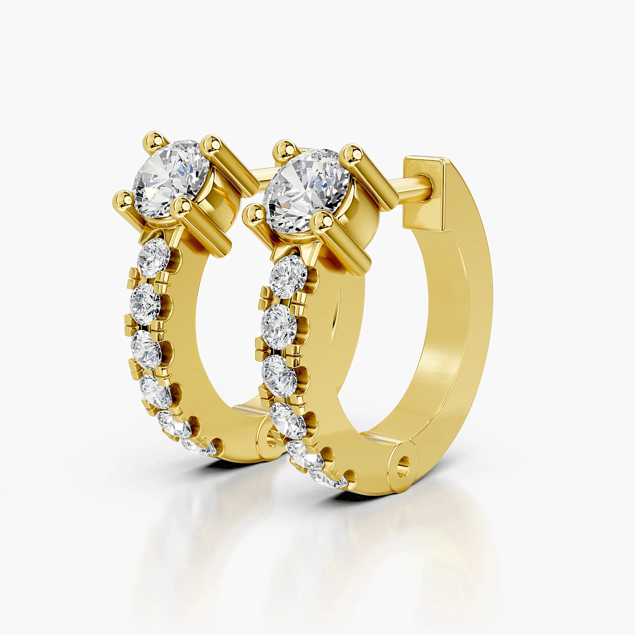 Pair of graduated round diamond hoop earrings with raised crown-set feature stones.