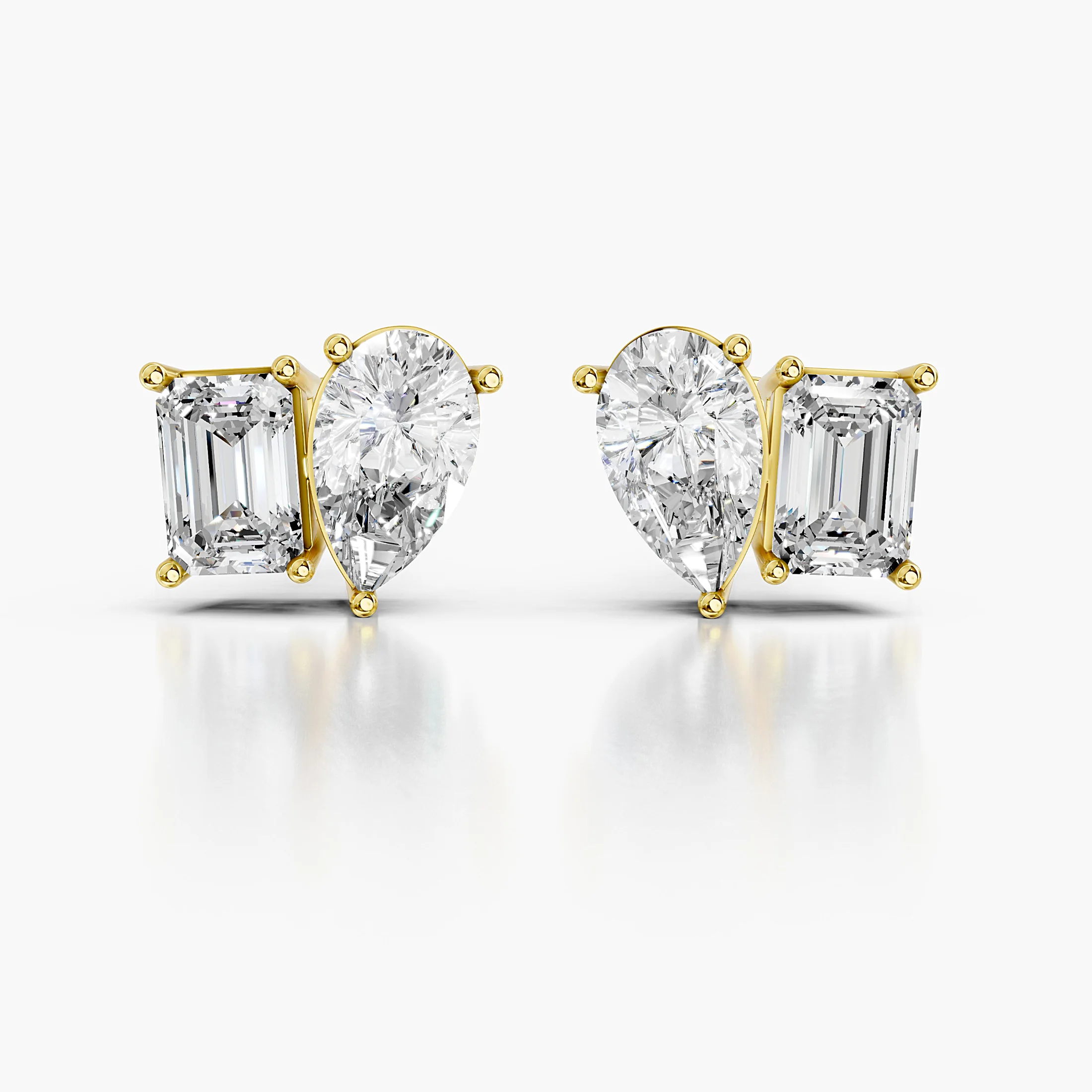 Pear-cut and emerald-cut diamond duo stud earrings in a mirrored design.
