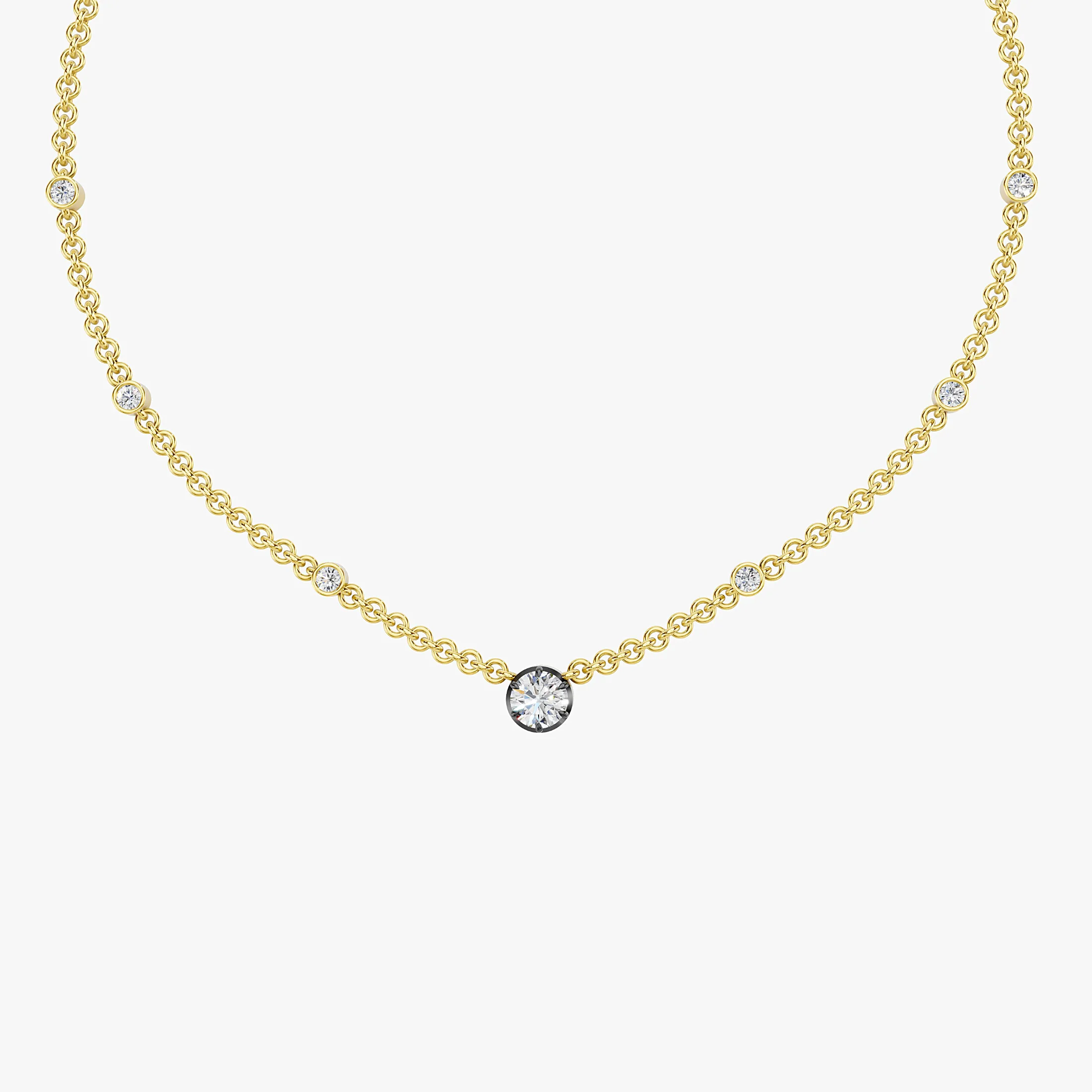 Seven-stone necklace with a larger round center diamond and six smaller round diamonds spaced along the chain