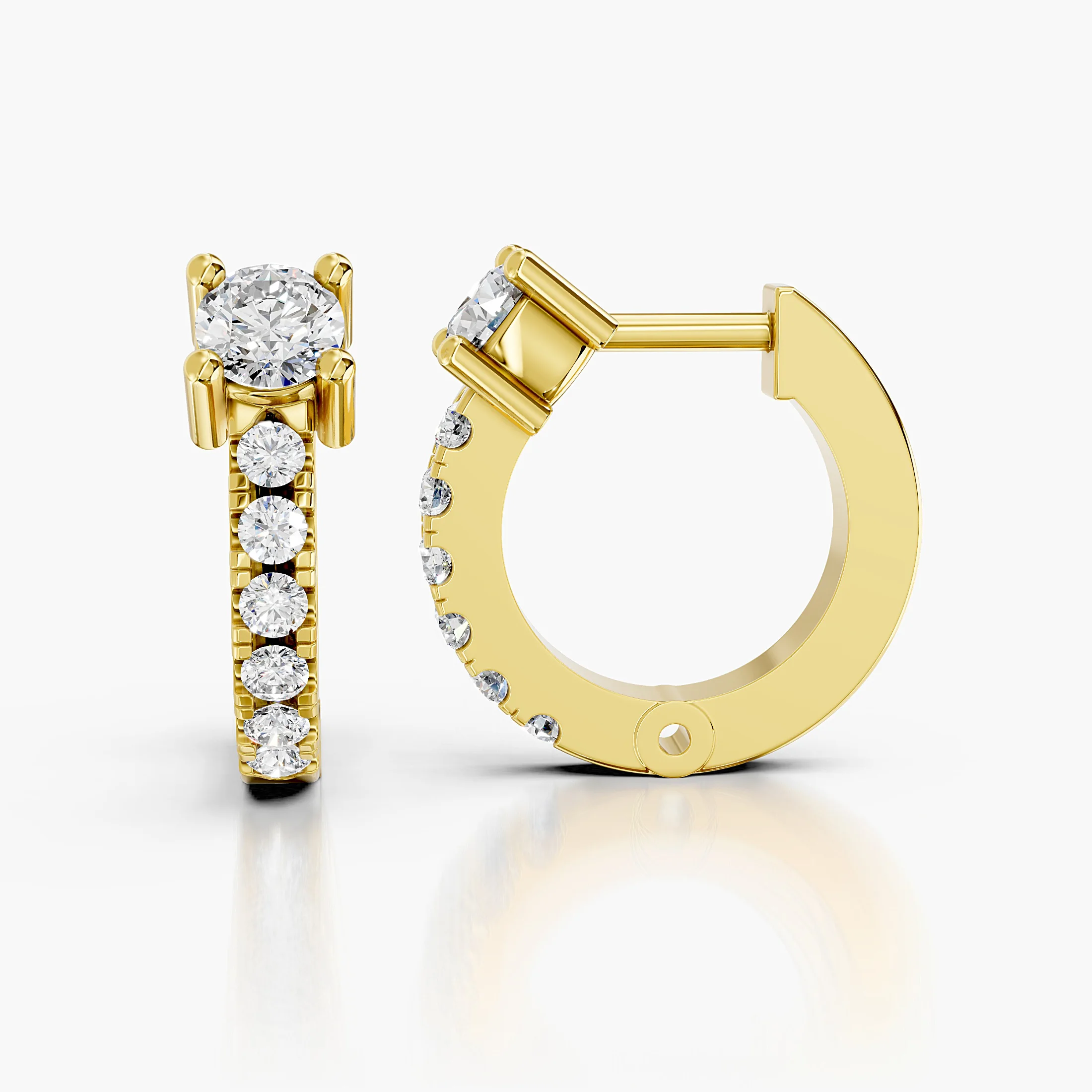 Pair of graduated round diamond hoop earrings with raised crown-set feature stones.