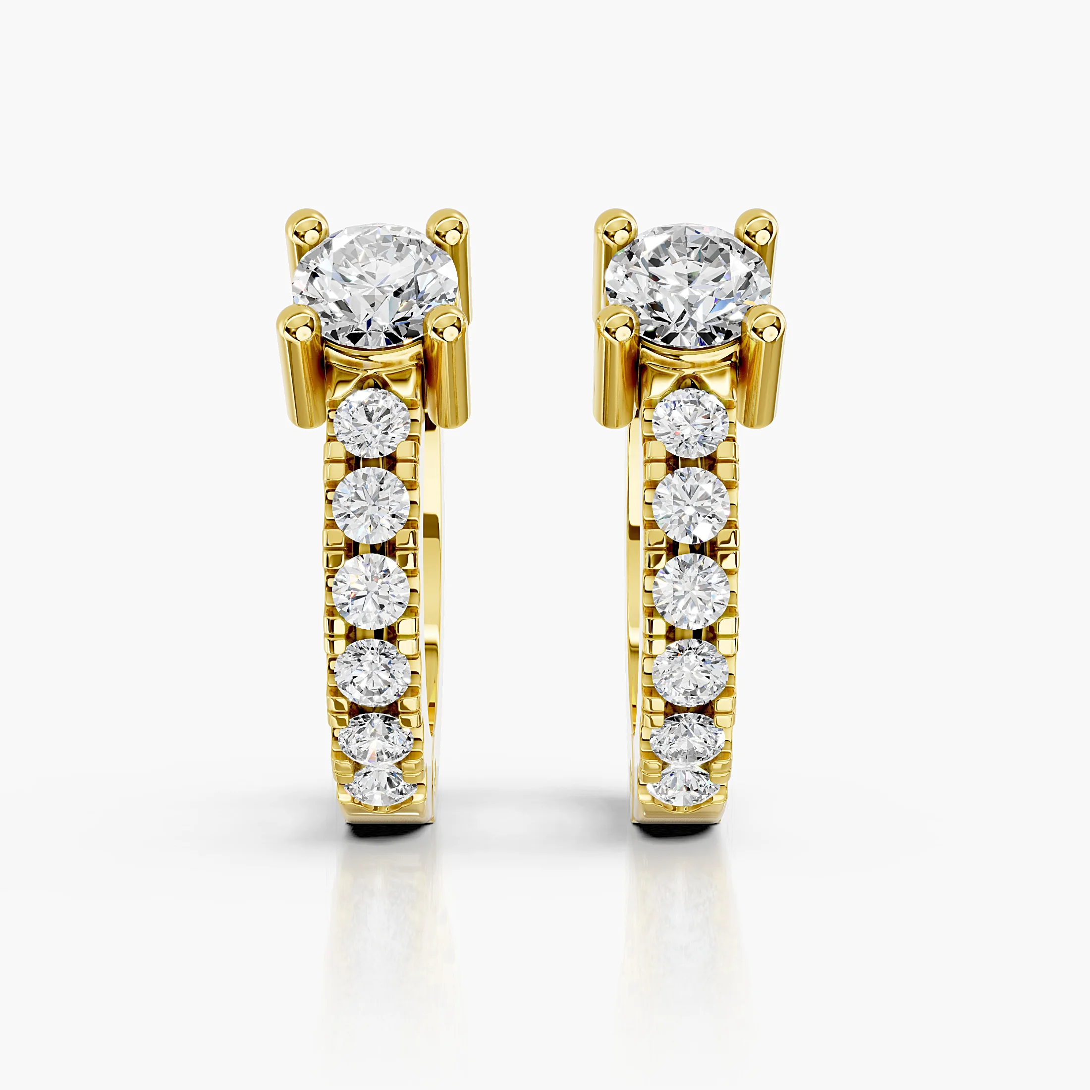 Pair of graduated round diamond hoop earrings with raised crown-set feature stones.