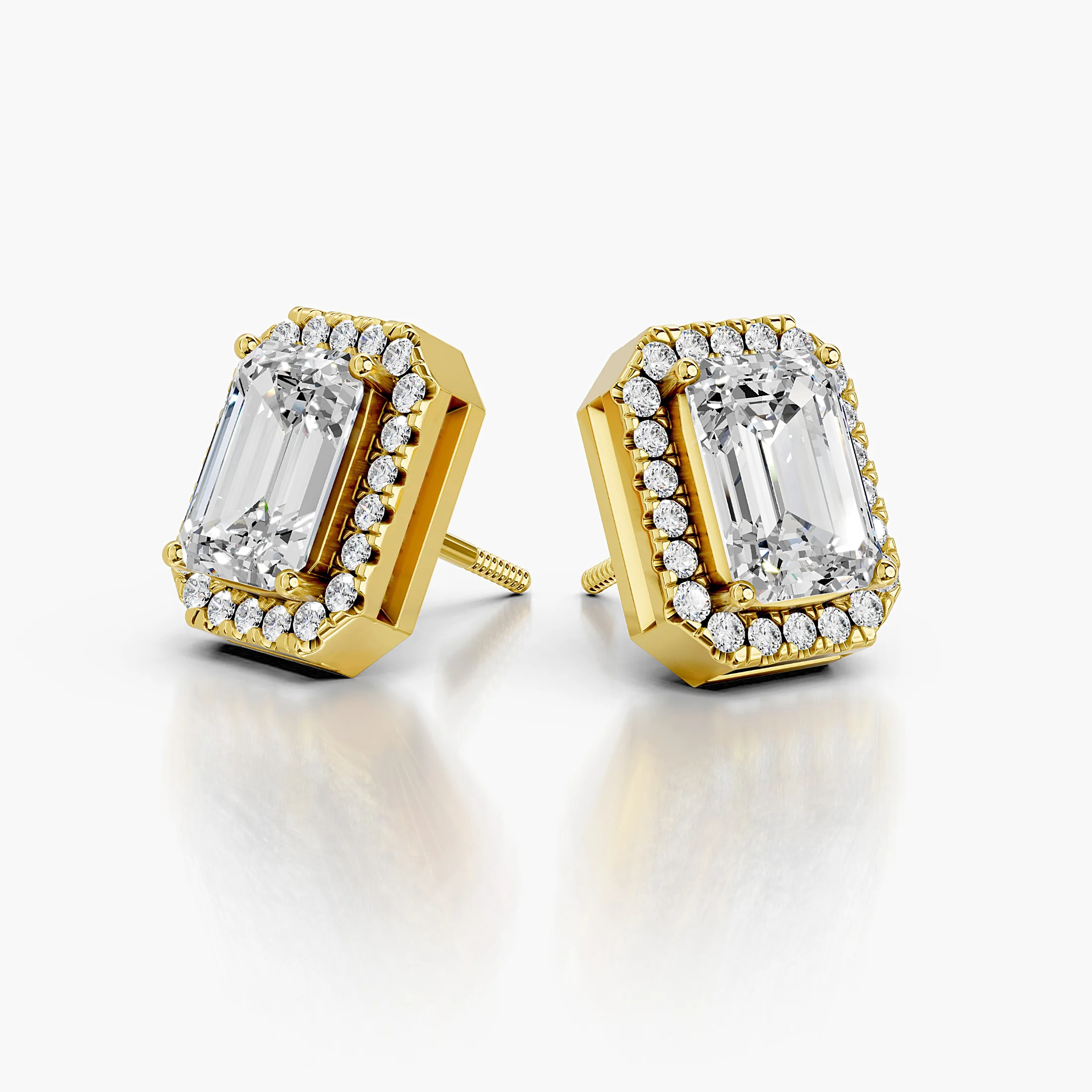 Emerald-cut diamond stud earrings with clipped-corner round diamond halos.