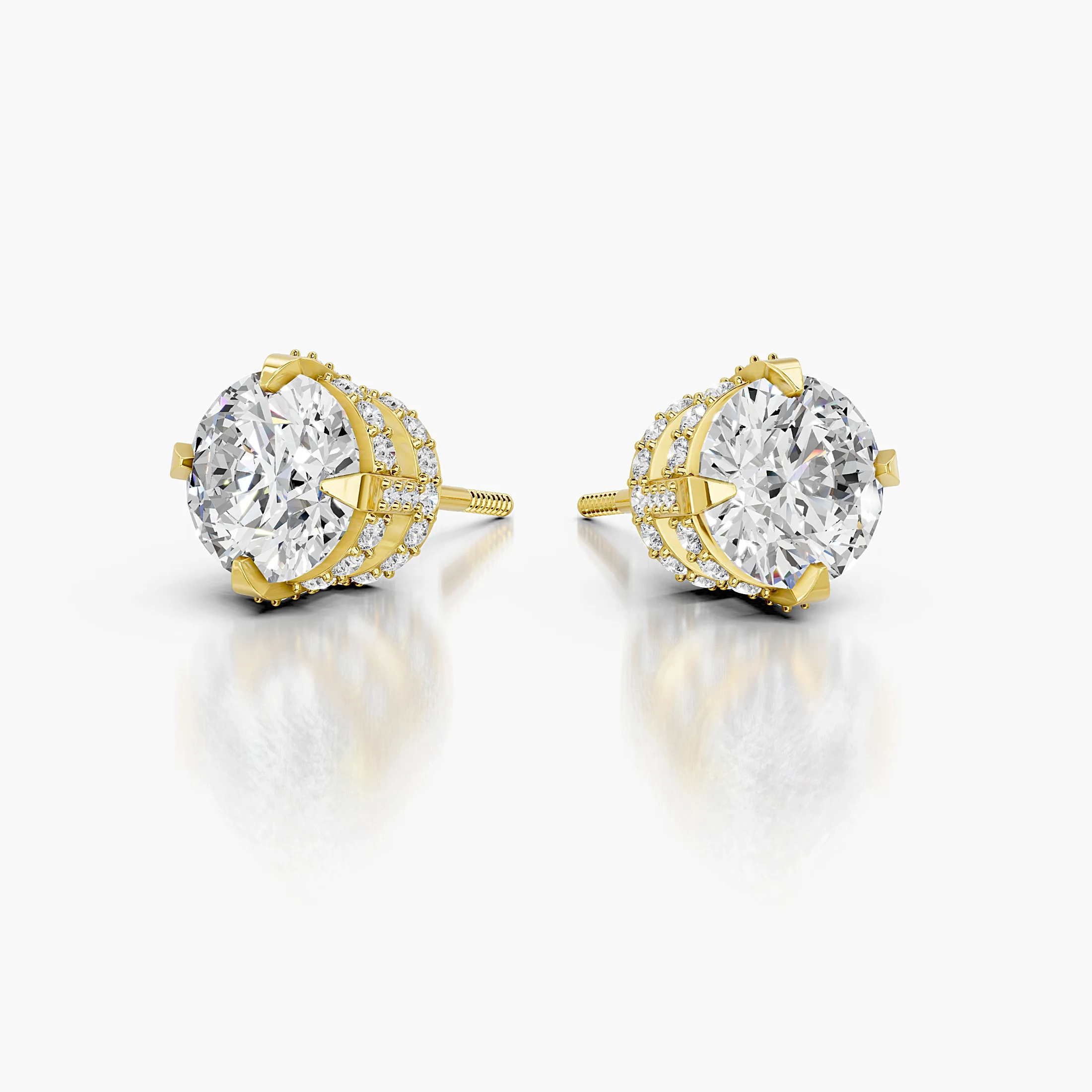 Pair of round diamond stud earrings with pavé cross-halo baskets and prominent solitaire centres.