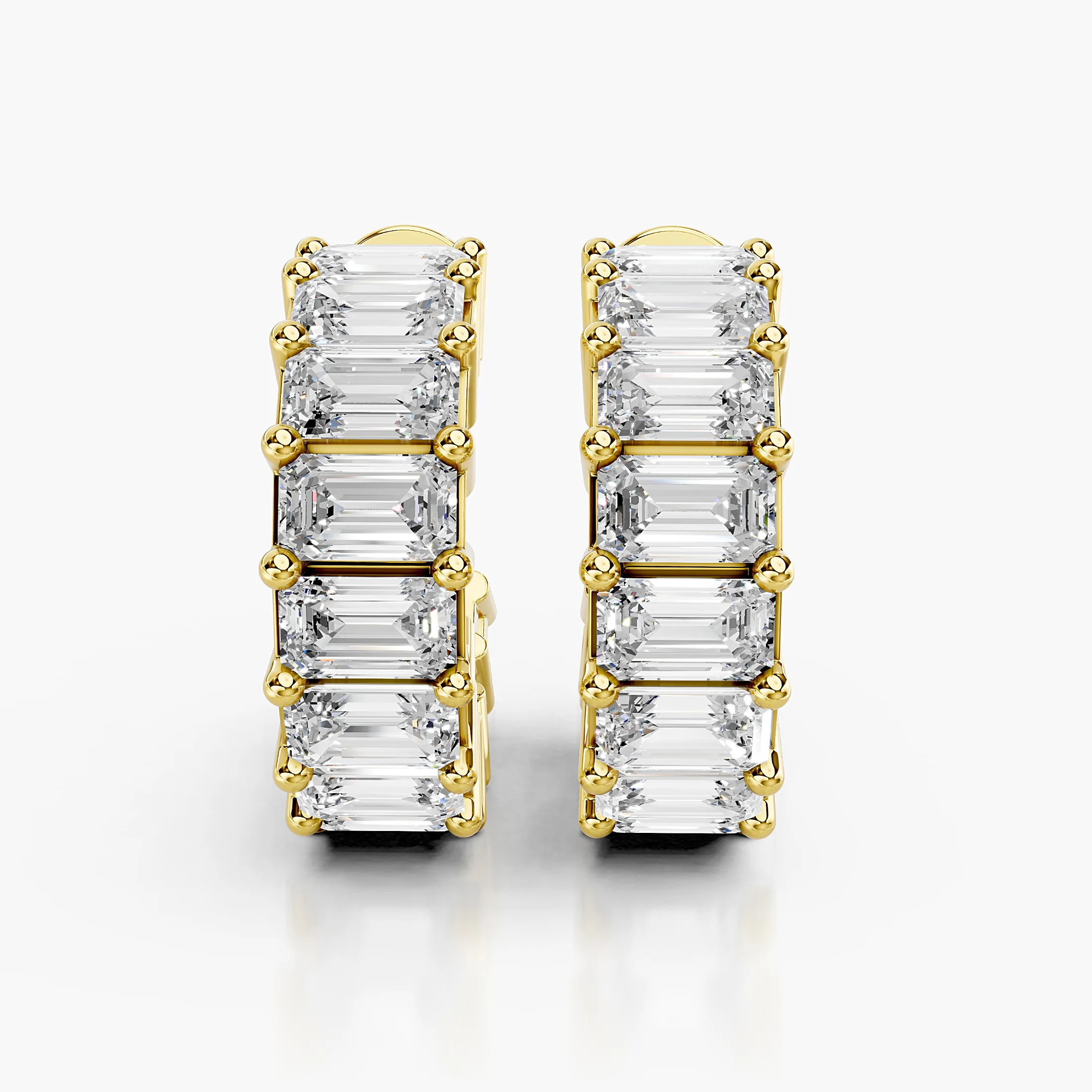Emerald-cut diamond statement hoop earrings with open four-prong galleries.