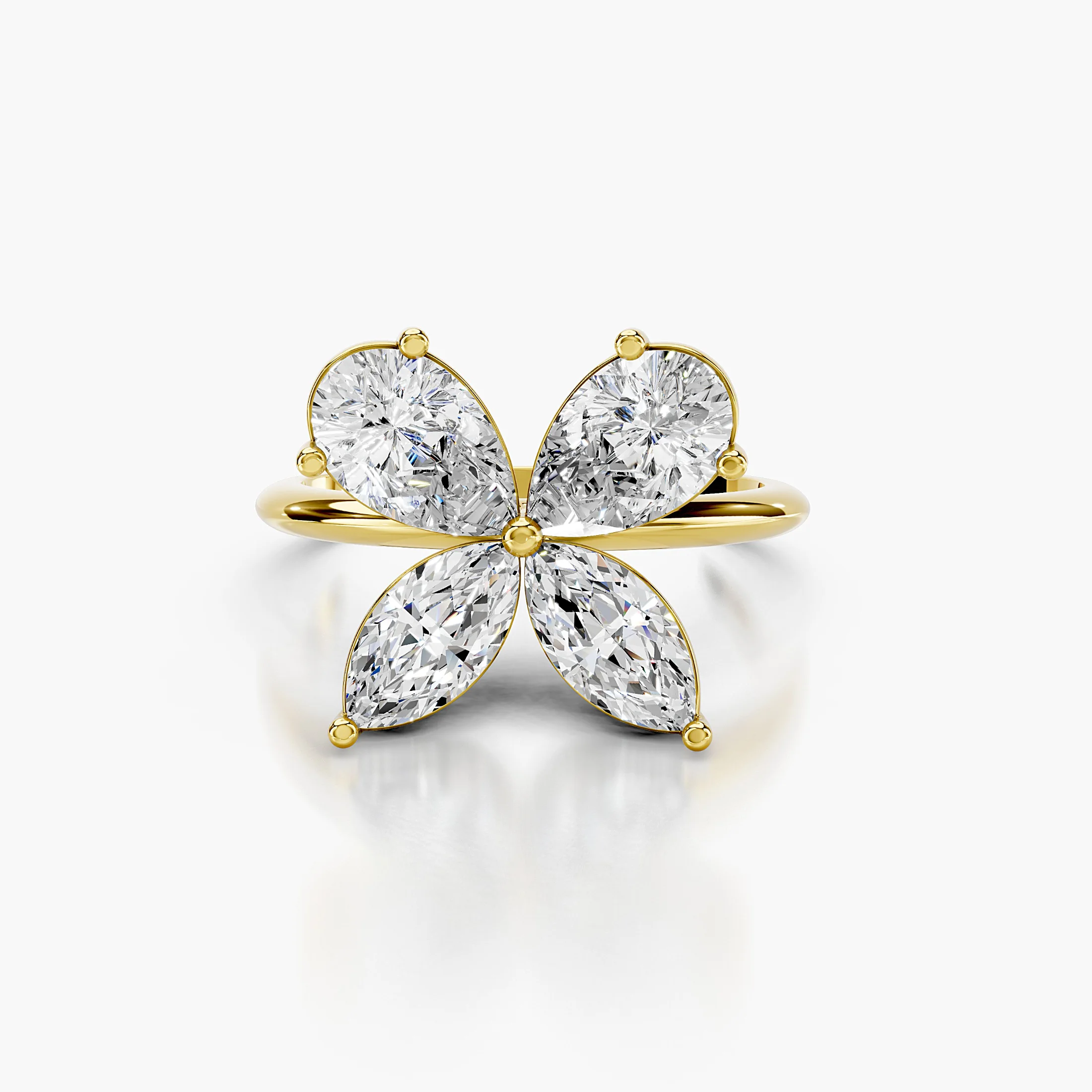 Four-petal diamond ring formed by two pear-cut and two marquise-cut stones on a polished band.
