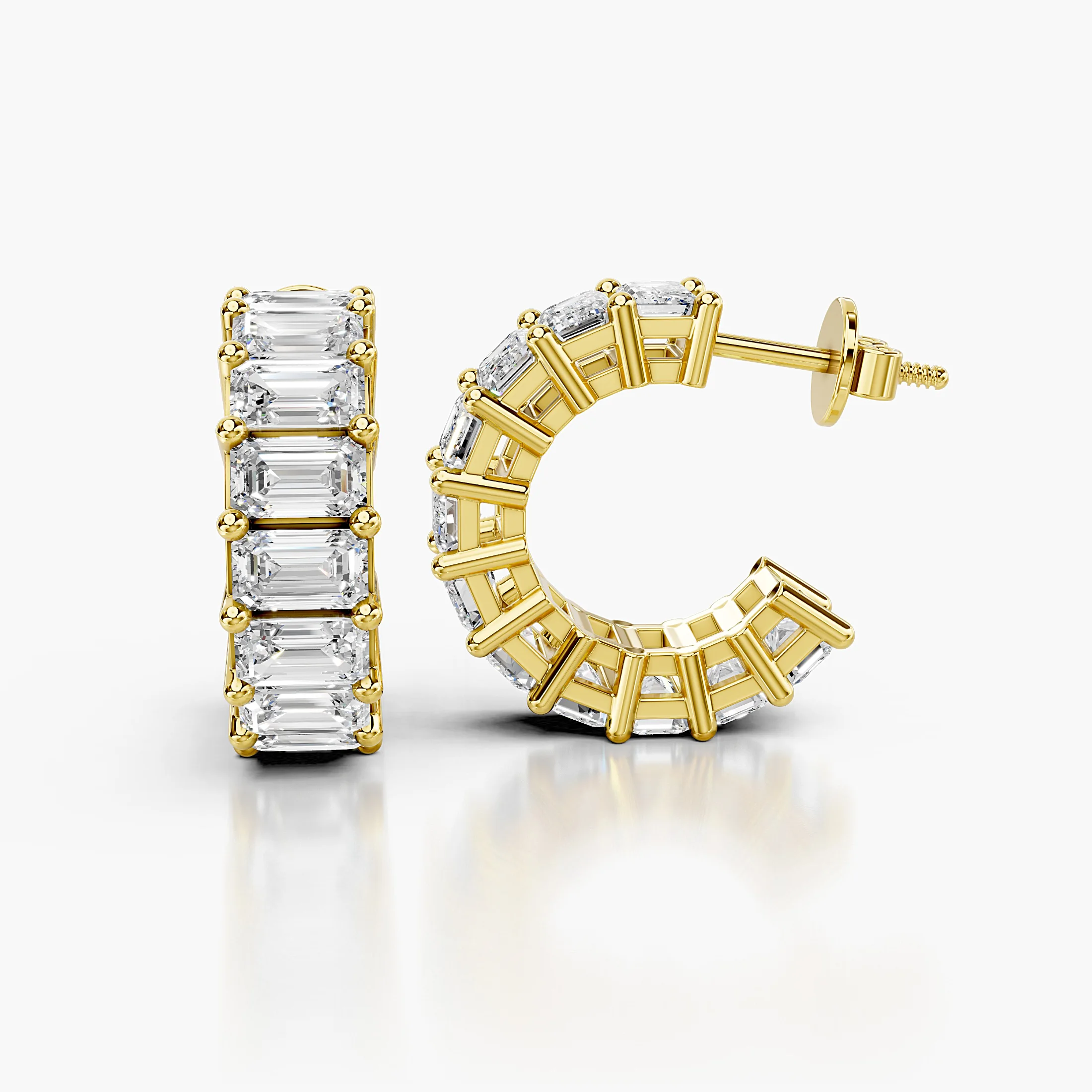 Emerald-cut diamond statement hoop earrings with open four-prong galleries.