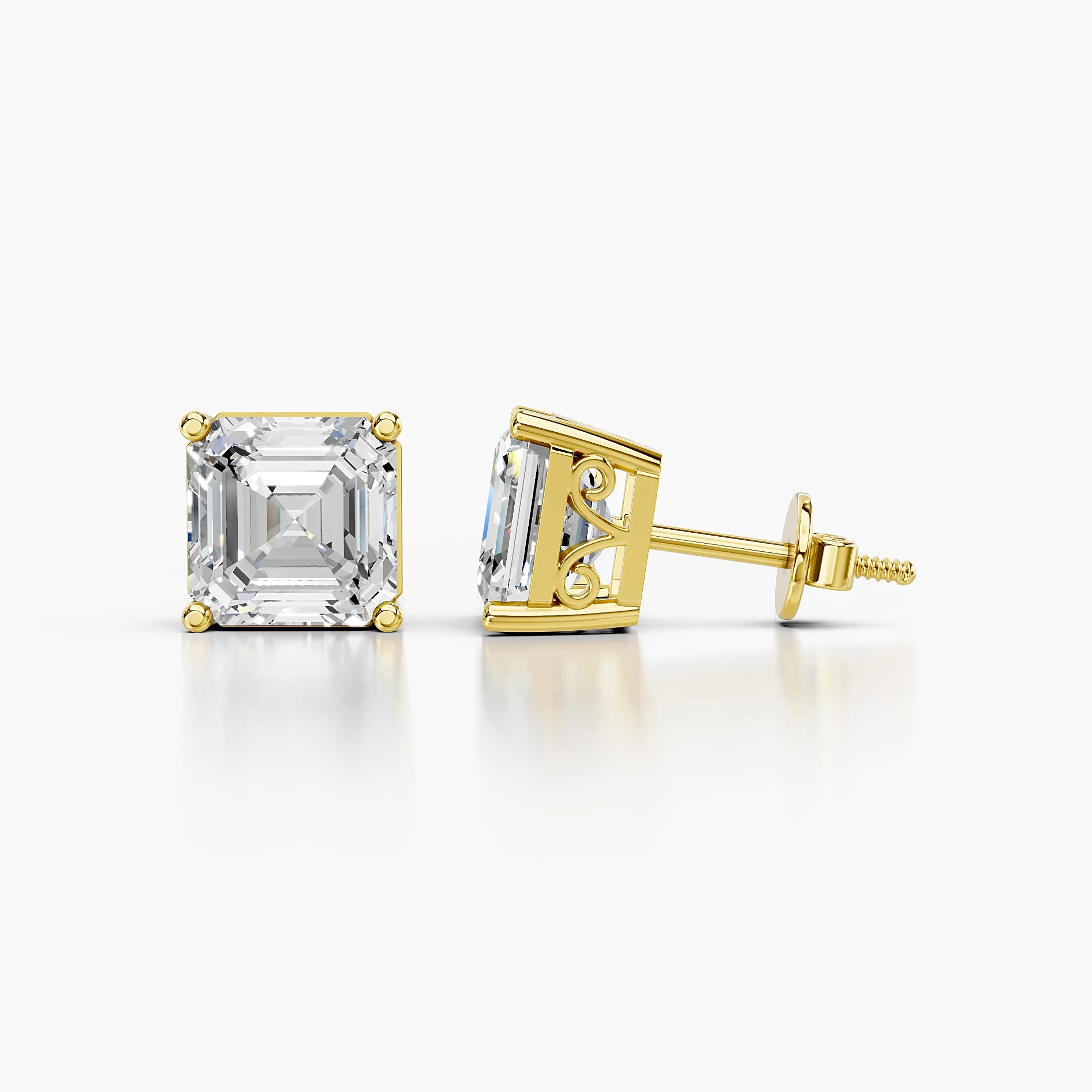 Pair of emerald-cut lab-grown diamond solitaire stud earrings in four-prong settings.