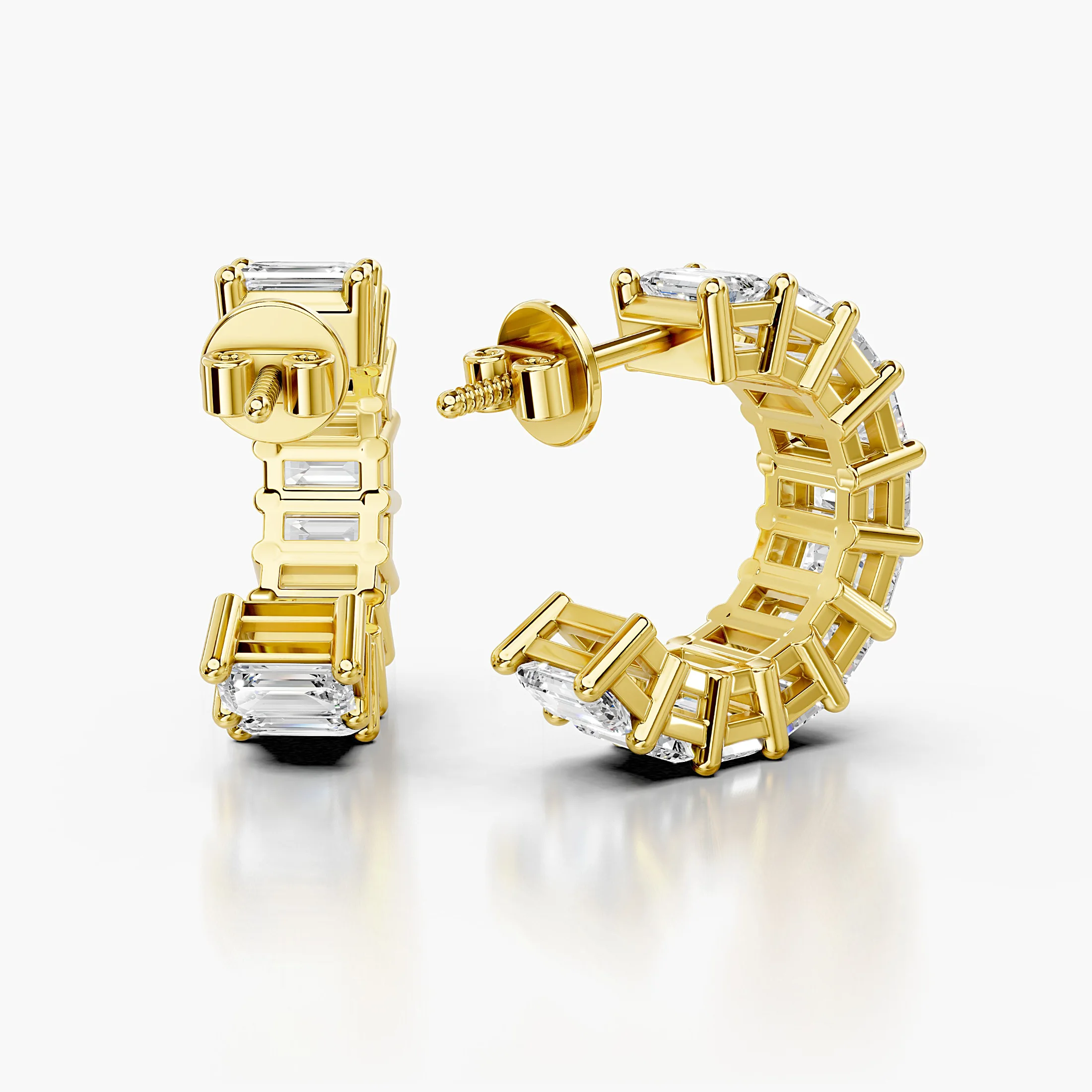 Emerald-cut diamond statement hoop earrings with open four-prong galleries.