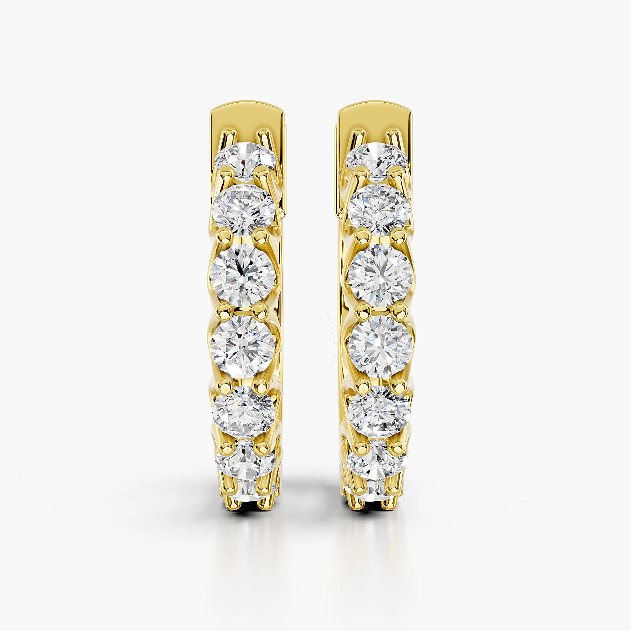Round diamond seven-stone hoop earrings with shared-prong settings.