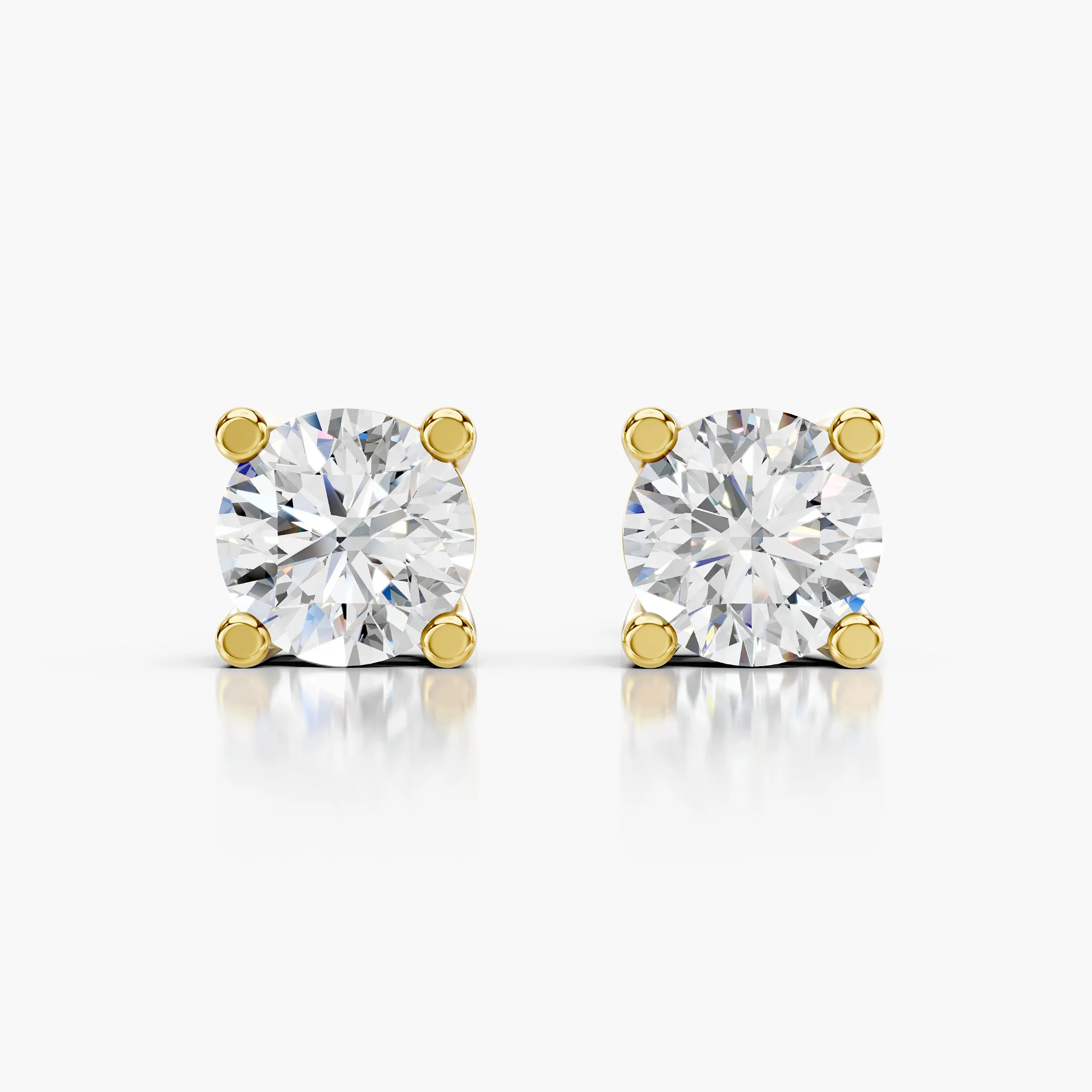 Round diamond solitaire stud earrings with four-prong basket settings and screw-back closures