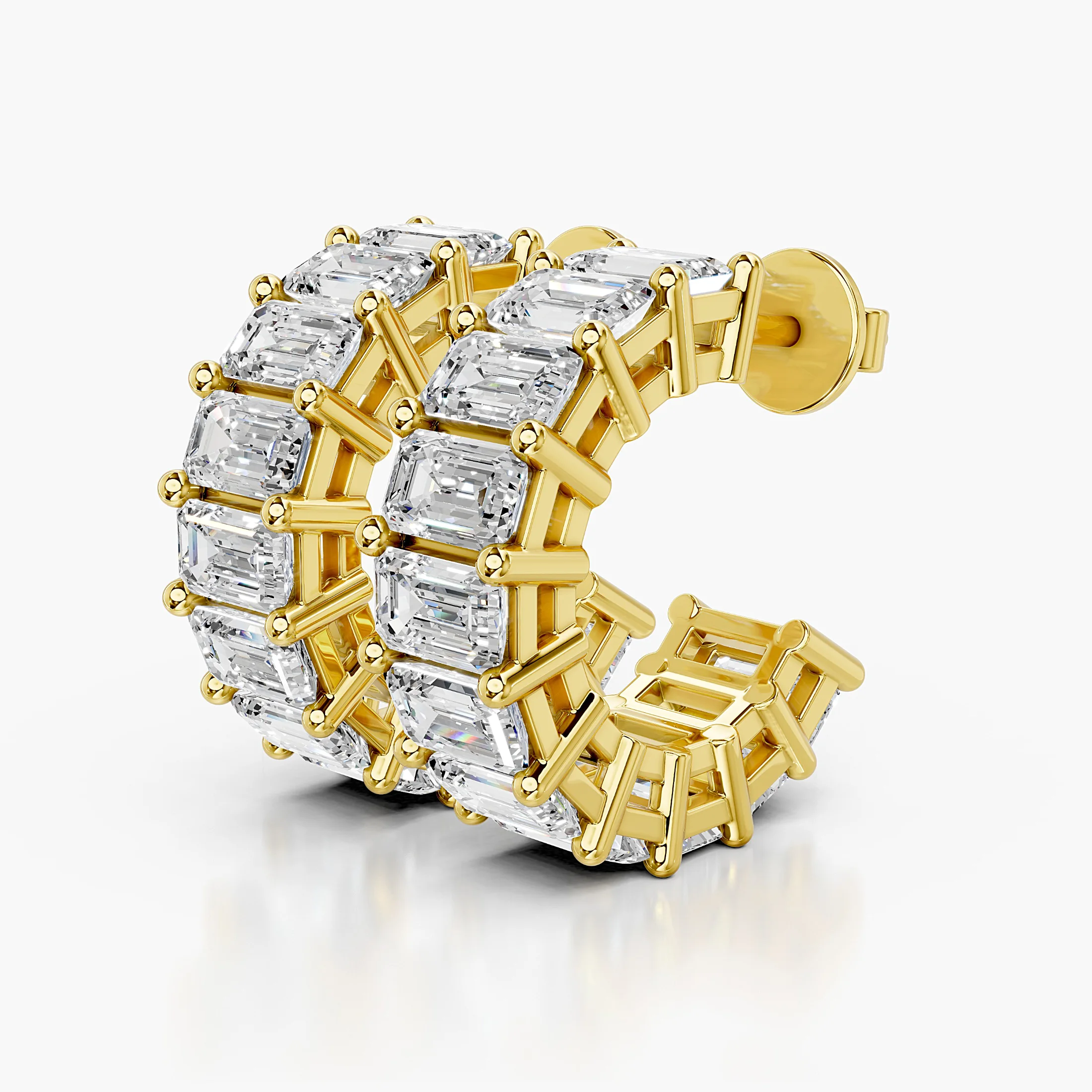 Emerald-cut diamond statement hoop earrings with open four-prong galleries.